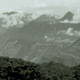 View looking westward across the valley from Aluni government station with the Victor Emmanuel Range in the distance just beyond the Strickland Gorge. The figure shows the extensive stands of secondary and primary forest covering hillsides and valley floor, just beyond the cultivated settlement area around the station.