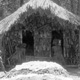 Celebrants at Female Spirit performance crawl into the sacred house, passing by earth-ovens topped with forest moss - Baiyer Valley, Hagen, PNG, 1965
