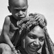 Woman with child, piglet, netbag, and stick – Tunda village, Pangia, Papua New Guinea, 1967 - (© P.J. Stewart & A.J. Strathern Archive)