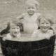 Image of Young children in wash tub, Sorn estate farm - Ayrshire, Scotland - c. 1930s - (© P.J. Stewart & A.J. Strathern Archive)